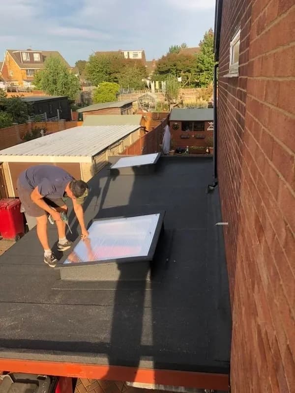 Flat Roofing Guys team installing a flat roof with skylights